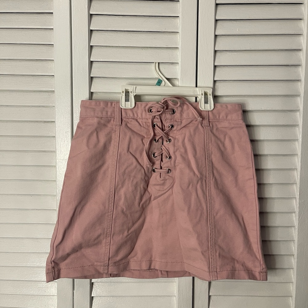 Pink laced up front mini skirt